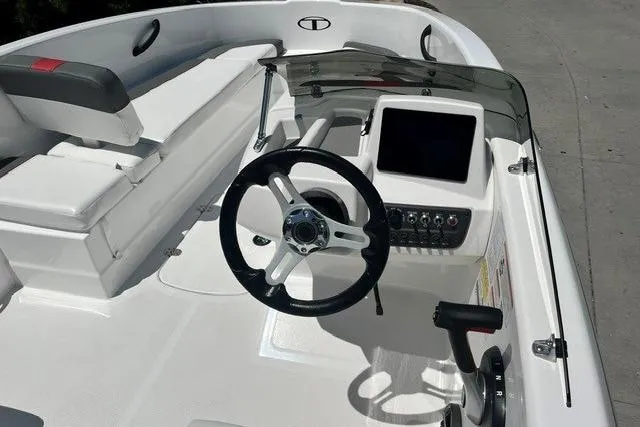 Slide: The Image of 2026 Tahoe T16 boat cockpit with steering wheel, control panel, and seating. - 62