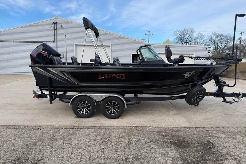 The Image of 2026 Lund 1975 Pro-V Sport boat on trailer, parked outdoors. - 0
