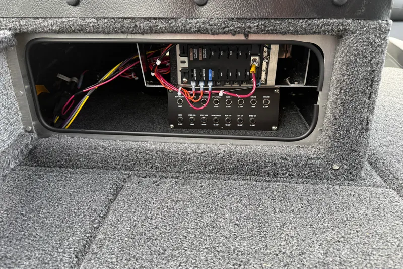 Slide: The Image of Electrical panel inside 2026 Lund 1975 Pro-V Sport boat, showcasing wiring and components. - 14