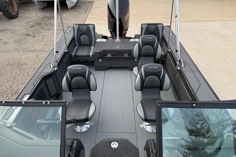 Slide: The Image of 2026 Lund 1975 Pro-V Sport boat interior with seating and steering console. - 16