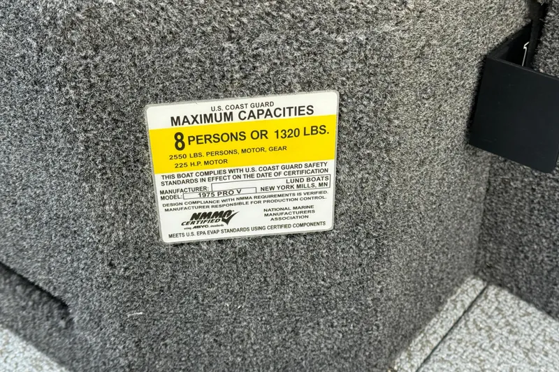 Slide: The Image of U.S. Coast Guard capacity label on 2026 Lund 1975 Pro-V Sport boat, 8 persons or 1320 lbs. - 21