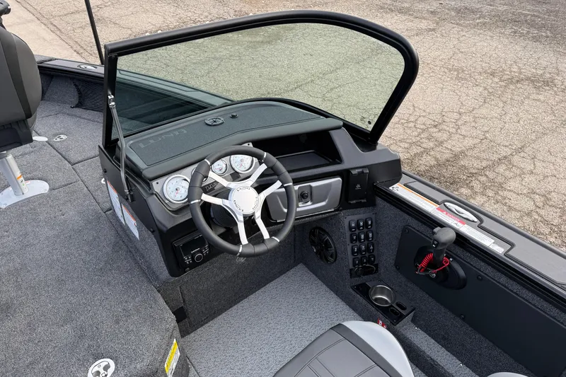 Slide: The Image of Interior of 2026 Lund 1975 Pro-V Sport boat with steering wheel and dashboard controls. - 22