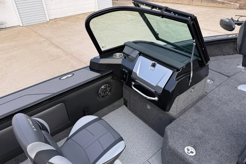 Slide: The Image of 2026 Lund 1975 Pro-V Sport boat interior with modern dashboard and seating. - 24