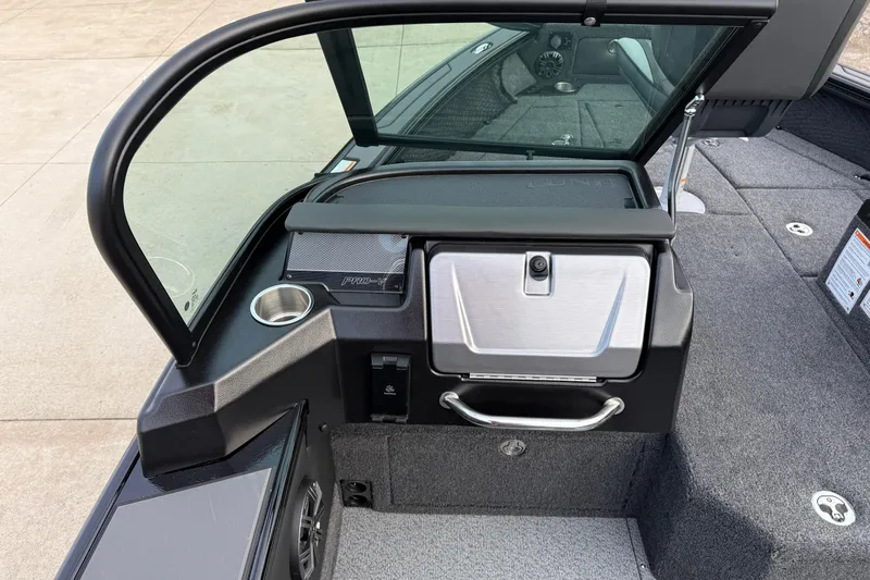 Slide: The Image of 2026 Lund 1975 Pro-V Sport boat interior with windshield and storage compartment. - 25