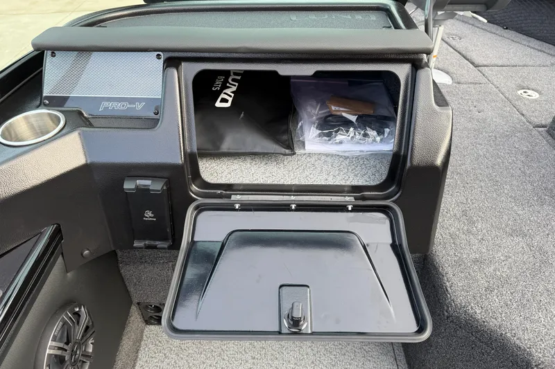 Slide: The Image of 2026 Lund 1975 Pro-V Sport boat storage compartment with open lid and interior view. - 27