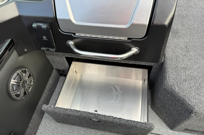 Slide: The Image of Open storage compartment in 2026 Lund 1975 Pro-V Sport boat, featuring sleek design and speaker. - 28