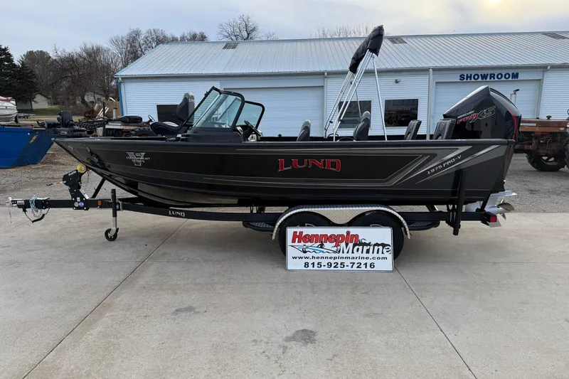 Slide: The Image of 2026 Lund 1975 Pro-V Sport boat on trailer outside Hennepin Marine showroom. - 3
