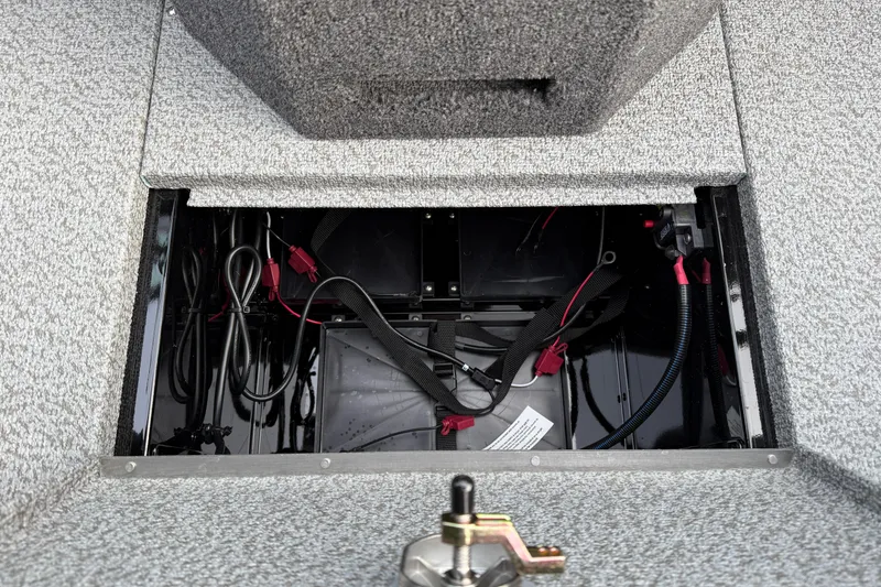 Slide: The Image of Open battery compartment of 2026 Lund 1975 Pro-V Sport boat, showing wiring and connections. - 30
