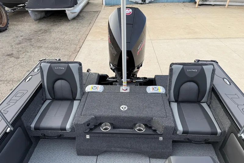 Slide: The Image of 2026 Lund 1975 Pro-V Sport boat interior with seating and motor, showcasing modern design. - 32