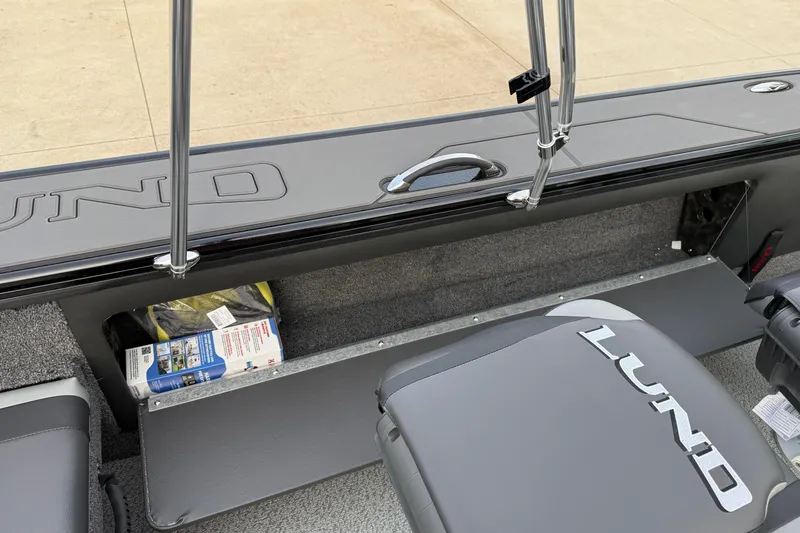 Slide: The Image of Interior of 2026 Lund 1975 Pro-V Sport boat, featuring storage compartment and seating. - 34