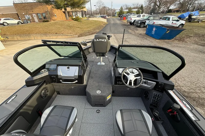 Slide: The Image of 2026 Lund 1975 Pro-V Sport boat interior with modern dashboard and seating. - 37