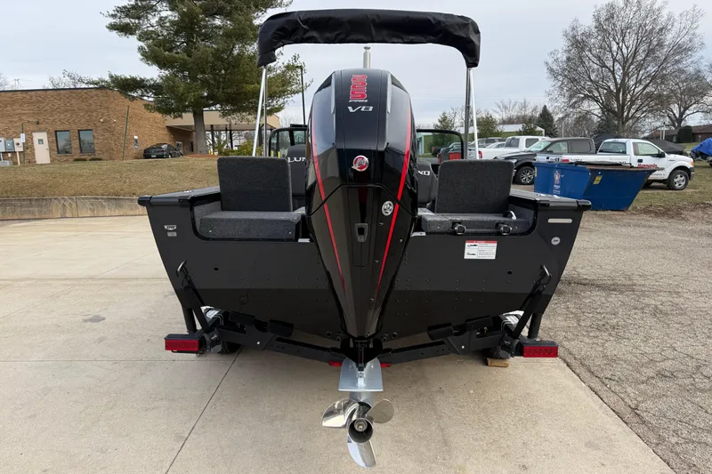 Slide: The Image of 2026 Lund 1975 Pro-V Sport boat with powerful V8 engine, parked outdoors. - 5