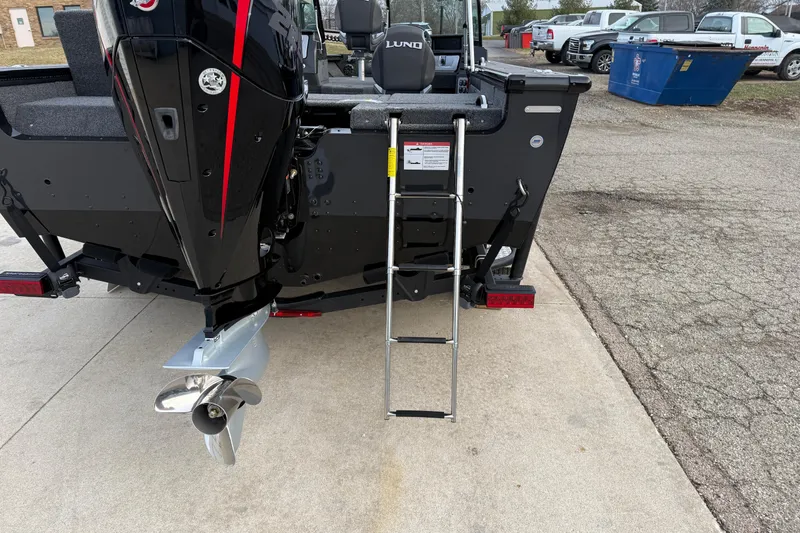 Slide: The Image of 2026 Lund 1975 Pro-V Sport boat rear view with motor and ladder. - 7