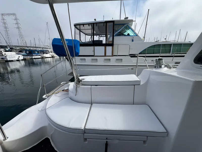 Slide: The Image of 2014 Gemini Legacy 35 yacht with white seating, docked in a marina. - 17