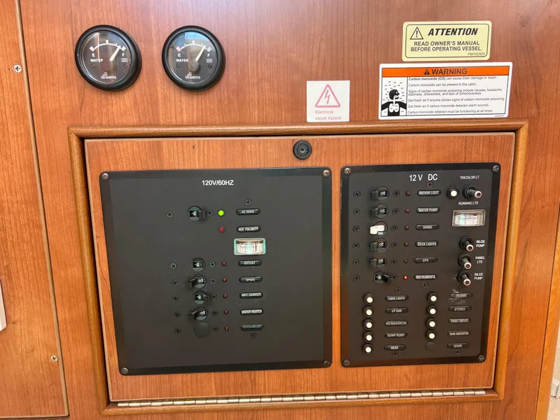 Slide: The Image of Electrical control panel on a 2014 Gemini Legacy 35 boat, featuring gauges and warning labels. - 25