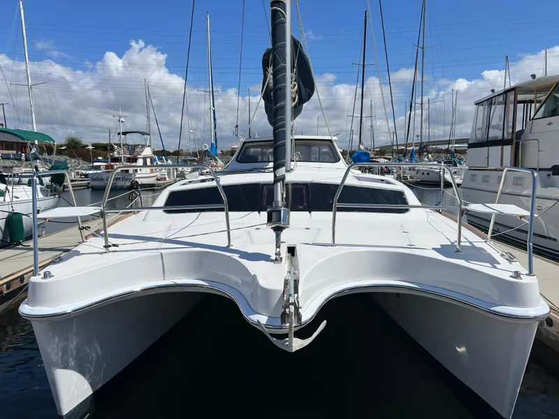 Slide: The Image of 2014 Gemini Legacy 35 catamaran docked at a marina under a blue sky. - 3