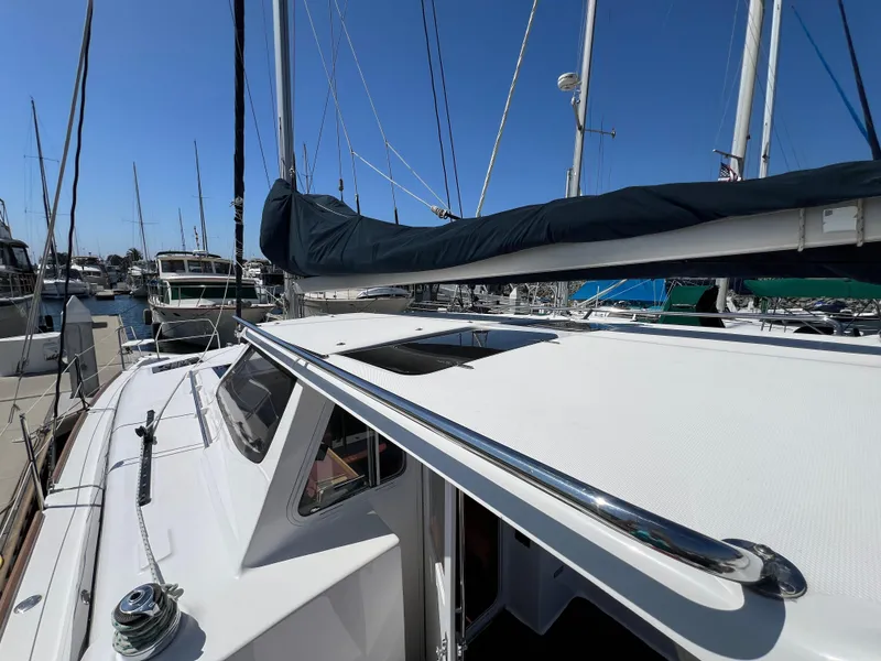 Slide: The Image of Sailboat Gemini Legacy 35, 2014 model, docked in a marina under clear blue skies. - 7