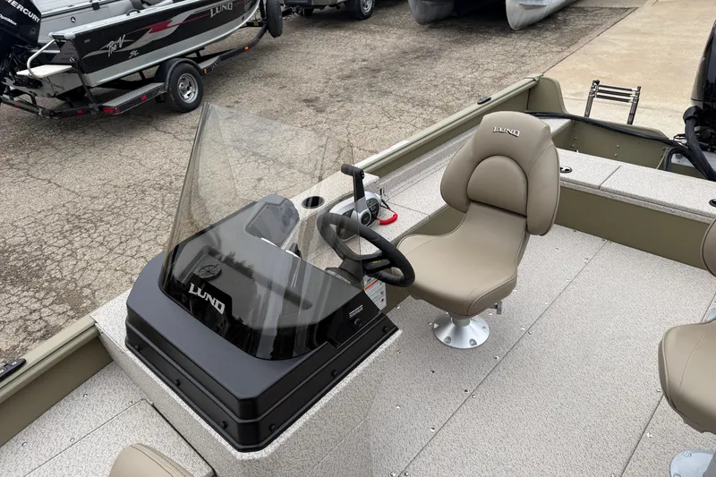 Slide: The Image of 2026 Lund 1675 Alaskan SS boat interior with steering console and seating. - 11