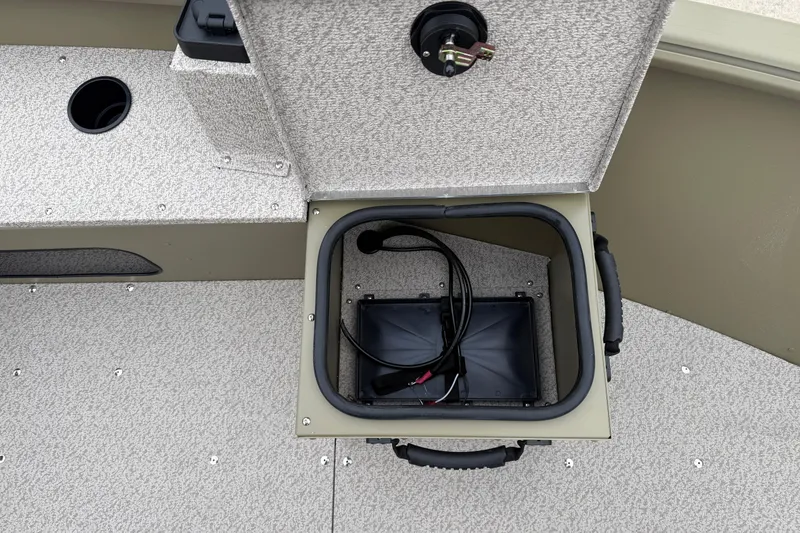 Slide: The Image of 2026 Lund 1675 Alaskan SS boat storage compartment with wiring and textured flooring. - 14