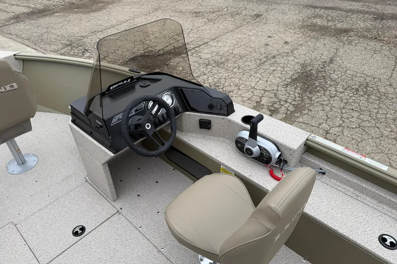 Slide: The Image of 2026 Lund 1675 Alaskan SS boat interior with steering wheel and controls. - 17