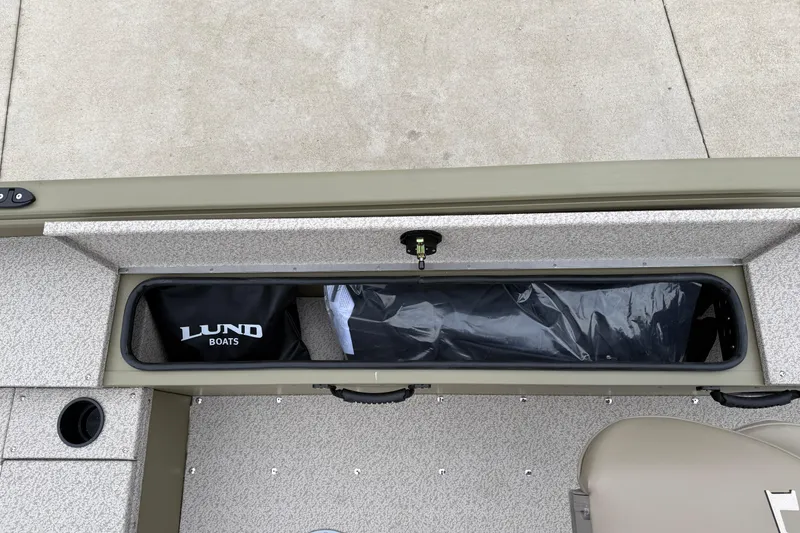 Slide: The Image of 2026 Lund 1675 Alaskan SS boat storage compartment with Lund Boats bag. - 25