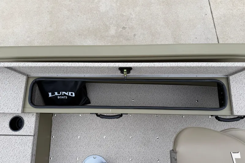 Slide: The Image of 2026 Lund 1675 Alaskan SS boat interior with storage compartment and Lund Boats bag. - 27