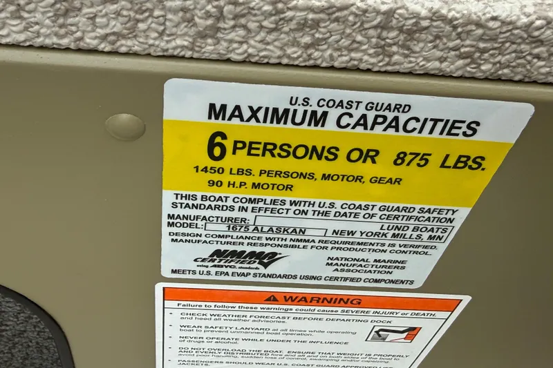 Slide: The Image of 2026 Lund 1675 Alaskan SS boat capacity label, 6 persons or 875 lbs, U.S. Coast Guard compliant. - 29