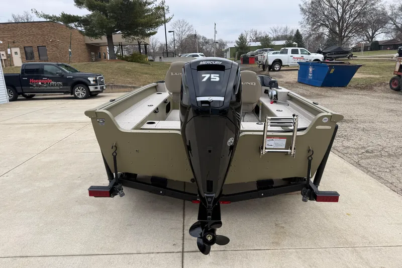 Slide: The Image of 2026 Lund 1675 Alaskan SS boat with Mercury 75 engine, parked outdoors. - 6