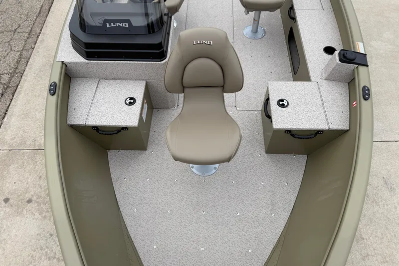 Slide: The Image of 2026 Lund 1675 Alaskan SS boat interior with beige seating and storage compartments. - 8