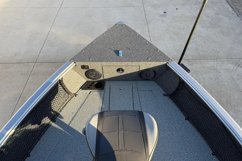 Slide: The Image of 2026 Lund 1875 Impact XS Sport boat interior with seating and storage compartments. - 11