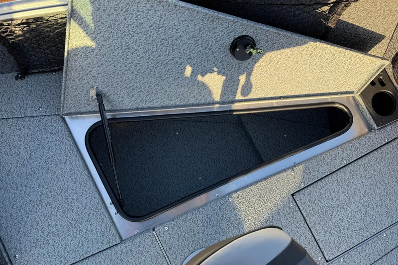 Slide: The Image of 2026 Lund 1875 Impact XS Sport boat interior storage compartment open. - 14