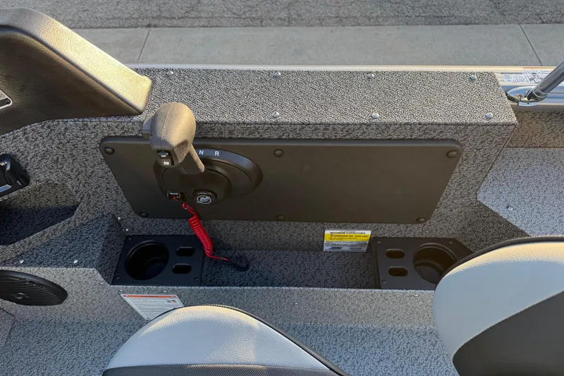 Slide: The Image of 2026 Lund 1875 Impact XS Sport boat interior with control panel and cup holders. - 21