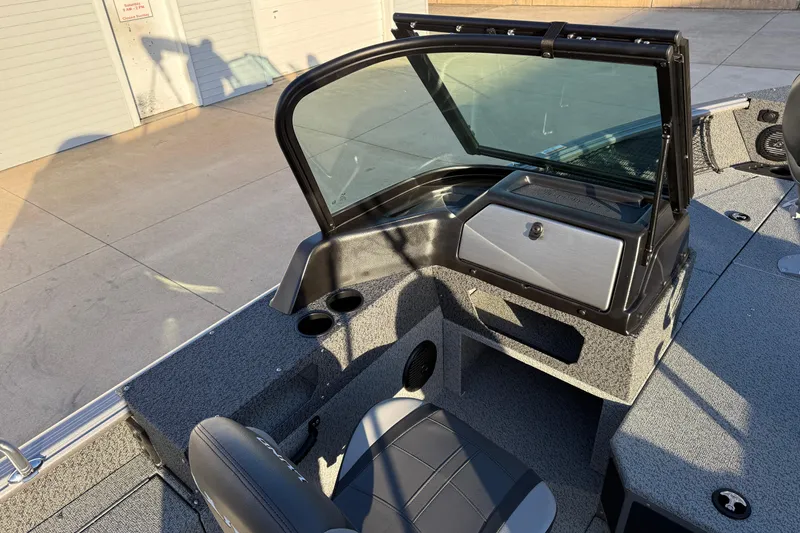 Slide: The Image of 2026 Lund 1875 Impact XS Sport boat interior with seating and windshield. - 23