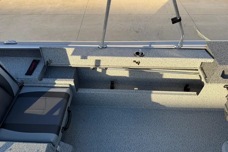 Slide: The Image of 2026 Lund 1875 Impact XS Sport boat interior with seating and storage compartments. - 27