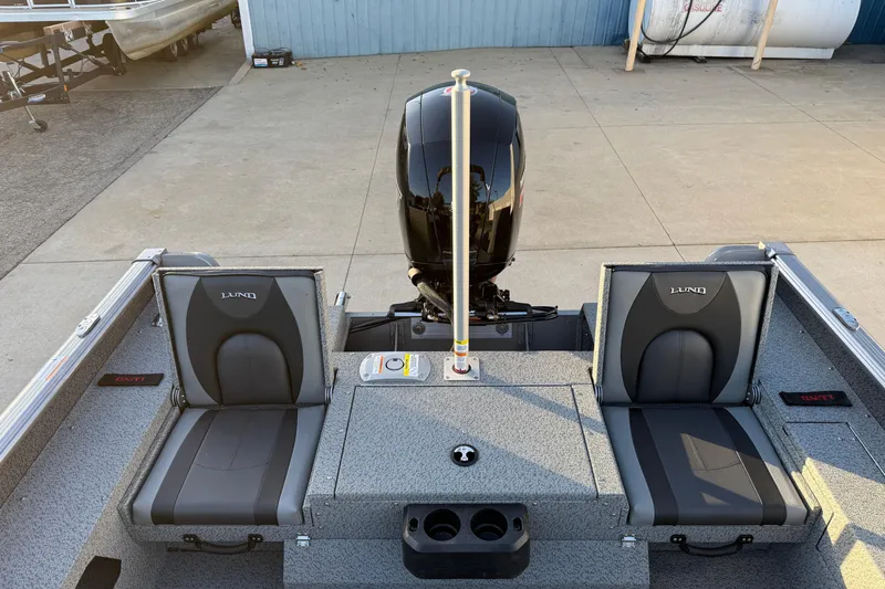 Slide: The Image of 2026 Lund 1875 Impact XS Sport boat interior with dual seats and motor. - 28