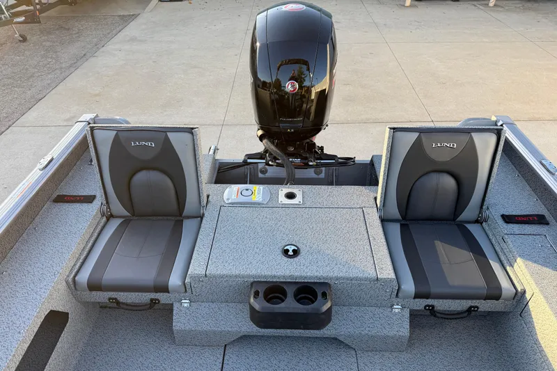 Slide: The Image of 2026 Lund 1875 Impact XS Sport boat interior with dual seats and motor. - 29