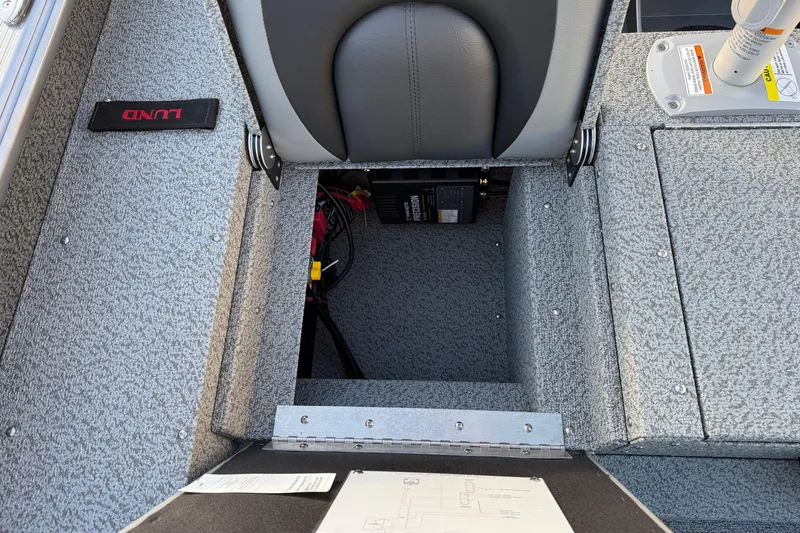 Slide: The Image of 2026 Lund 1875 Impact XS Sport boat interior with storage compartment and seat. - 33