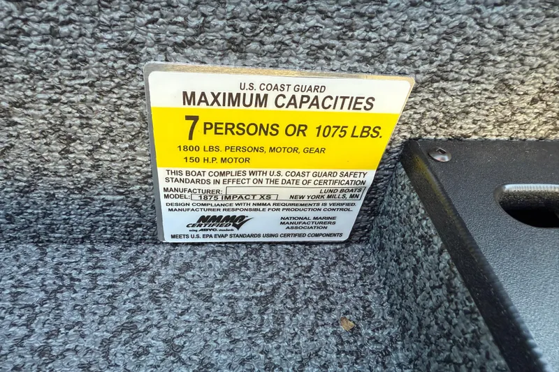 Slide: The Image of Capacity label for 2026 Lund 1875 Impact XS Sport, 7 persons or 1075 lbs. - 34