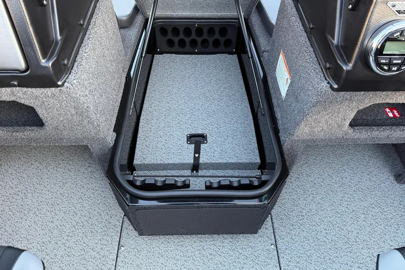 Slide: The Image of 2026 Lund 1775 Impact XS Sport boat interior with storage compartment and control panel. - 13