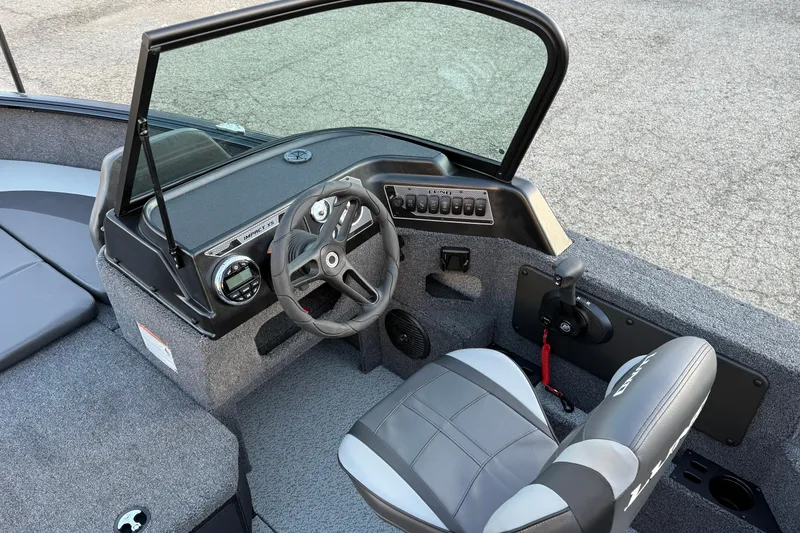Slide: The Image of 2026 Lund 1775 Impact XS Sport boat interior with steering wheel and controls. - 15