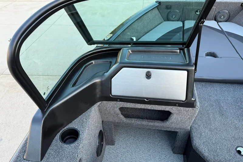 Slide: The Image of 2026 Lund 1775 Impact XS Sport boat interior with windshield and storage compartment. - 18