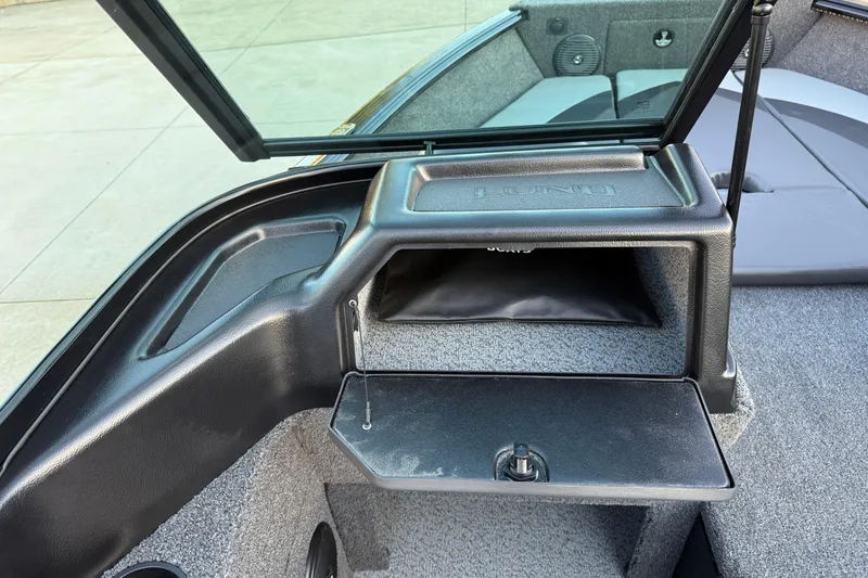 Slide: The Image of 2026 Lund 1775 Impact XS Sport boat interior with storage compartment and seating area. - 19