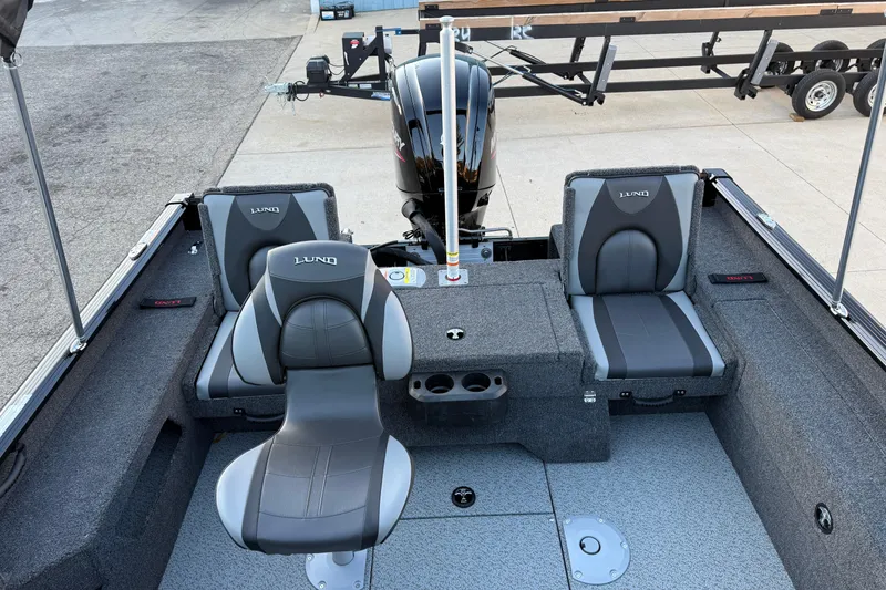 Slide: The Image of 2026 Lund 1775 Impact XS Sport boat interior with gray seating and motor. - 20