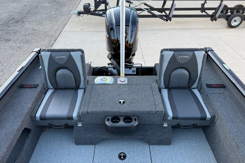 Slide: The Image of 2026 Lund 1775 Impact XS Sport boat interior with two gray seats and motor. - 22