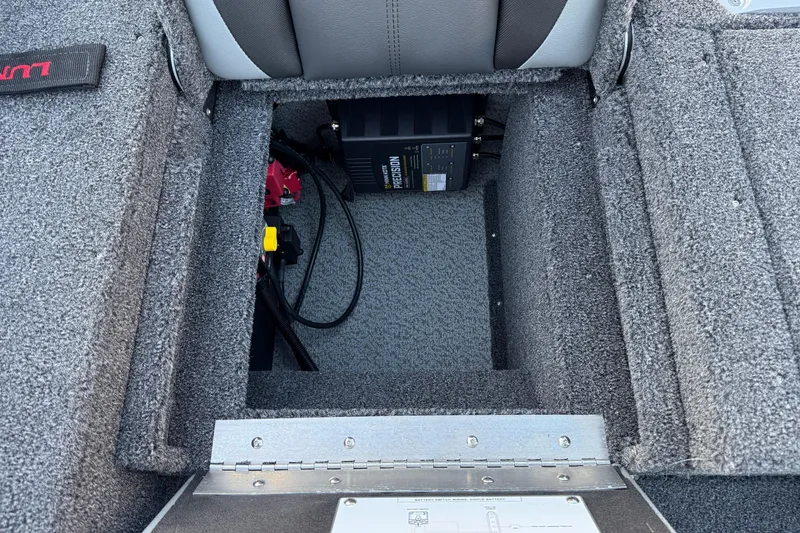 Slide: The Image of 2026 Lund 1775 Impact XS Sport boat battery compartment with precision charger. - 24