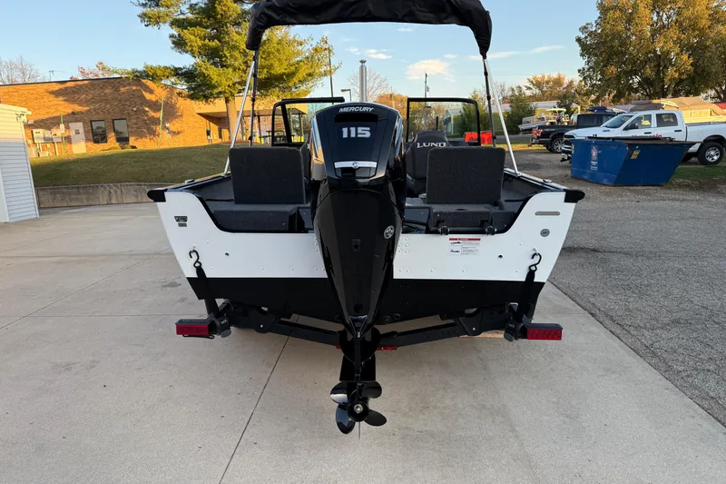 Slide: The Image of 2026 Lund 1775 Impact XS Sport boat with Mercury 115 engine, parked outdoors. - 6
