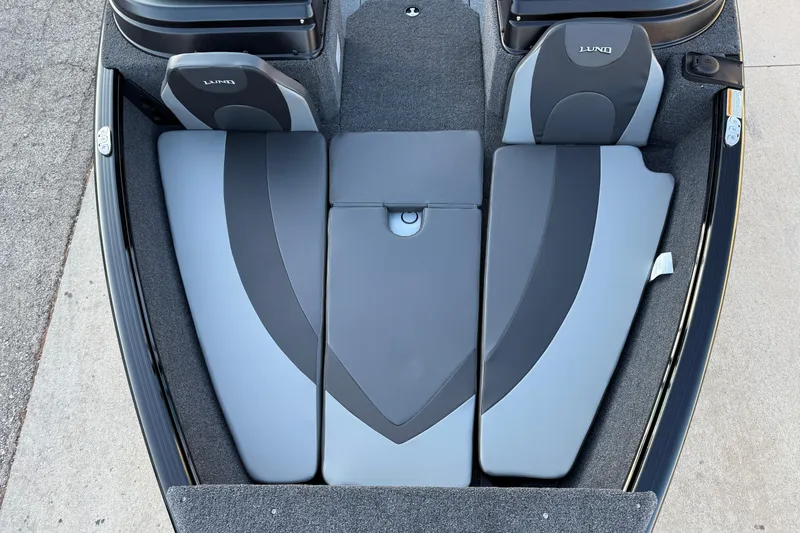 Slide: The Image of 2026 Lund 1775 Impact XS Sport boat interior with gray seating and storage compartments. - 8