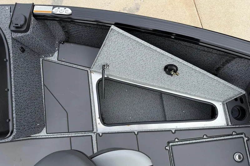 Slide: The Image of 2026 Lund 1775 Impact XS Sport boat interior with open storage compartment. - 10