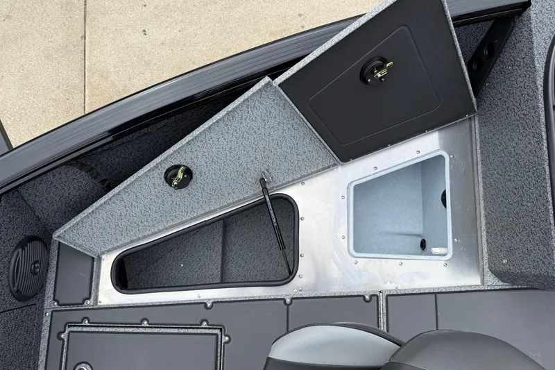 Slide: The Image of 2026 Lund 1775 Impact XS Sport boat interior with open storage compartments. - 11