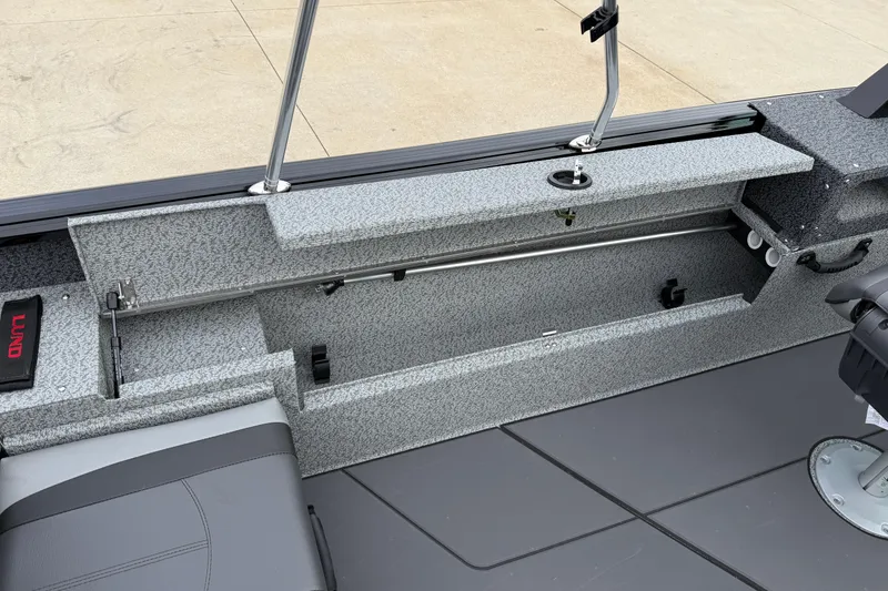Slide: The Image of 2026 Lund 1775 Impact XS Sport boat interior with storage compartments and seating. - 22